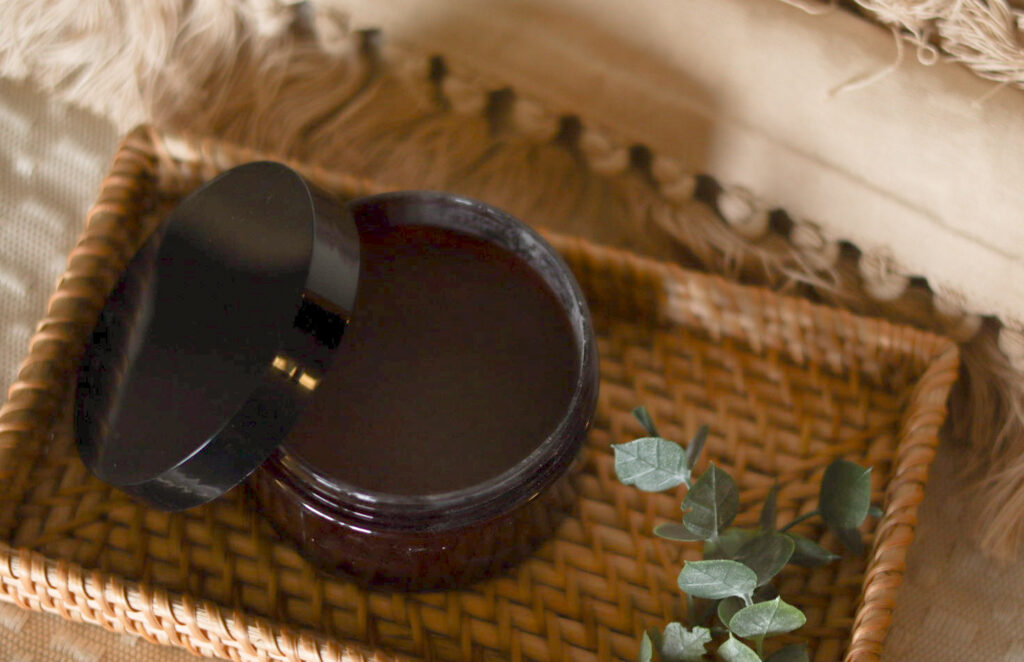 teeth powder with open lid on woven tray