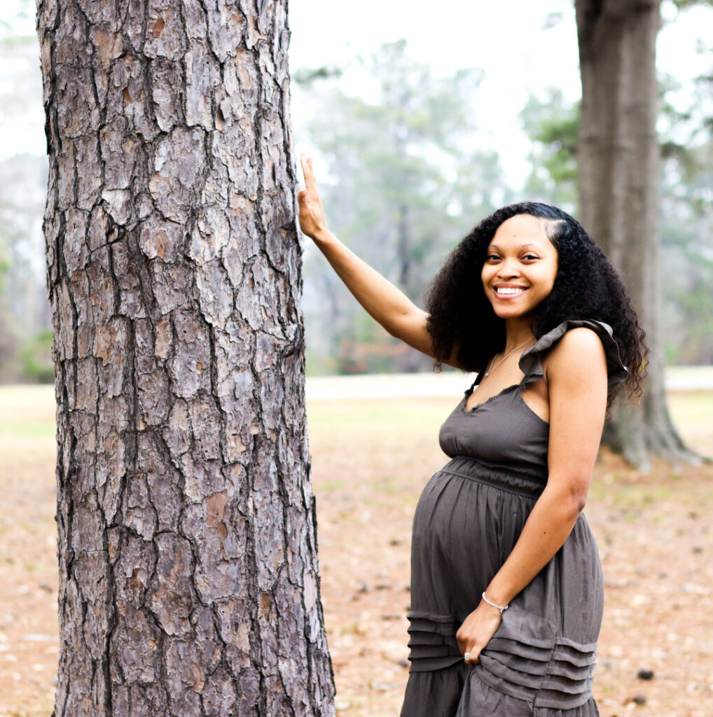 Woman standing next to a tree