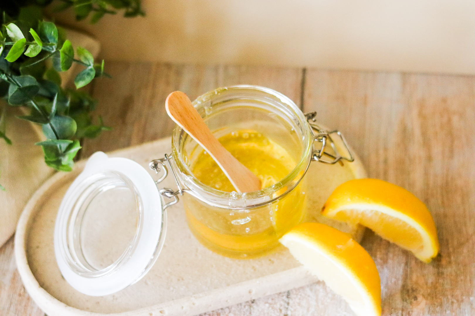 making sugar wax recipe with wooden spreading stick on a plaque tray