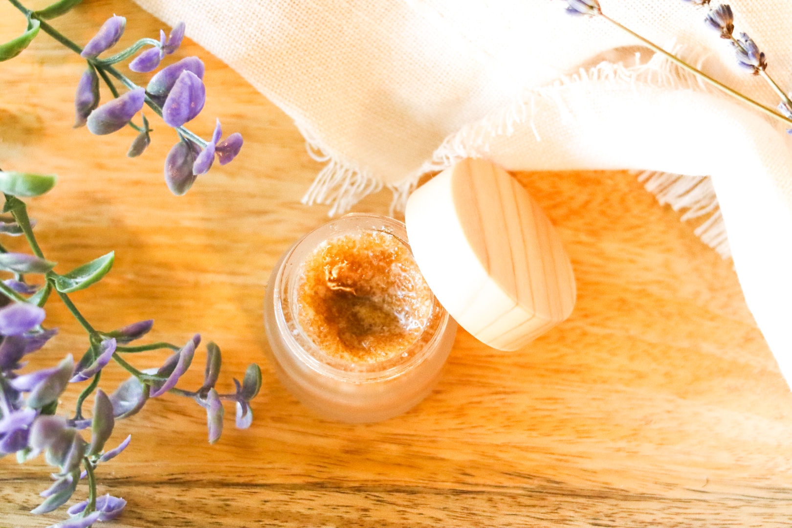 home made lip scrub on wooden tray next to lavendar