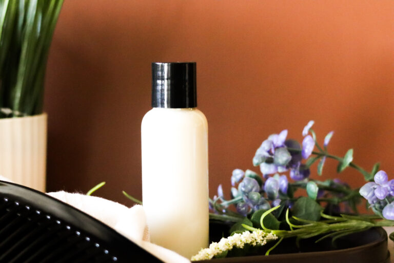 homemade leave in hair moisturizer next to comb and plant