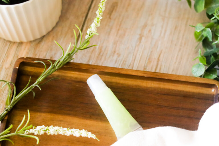 natural itch relief for bug bites on wooden tray next to plant
