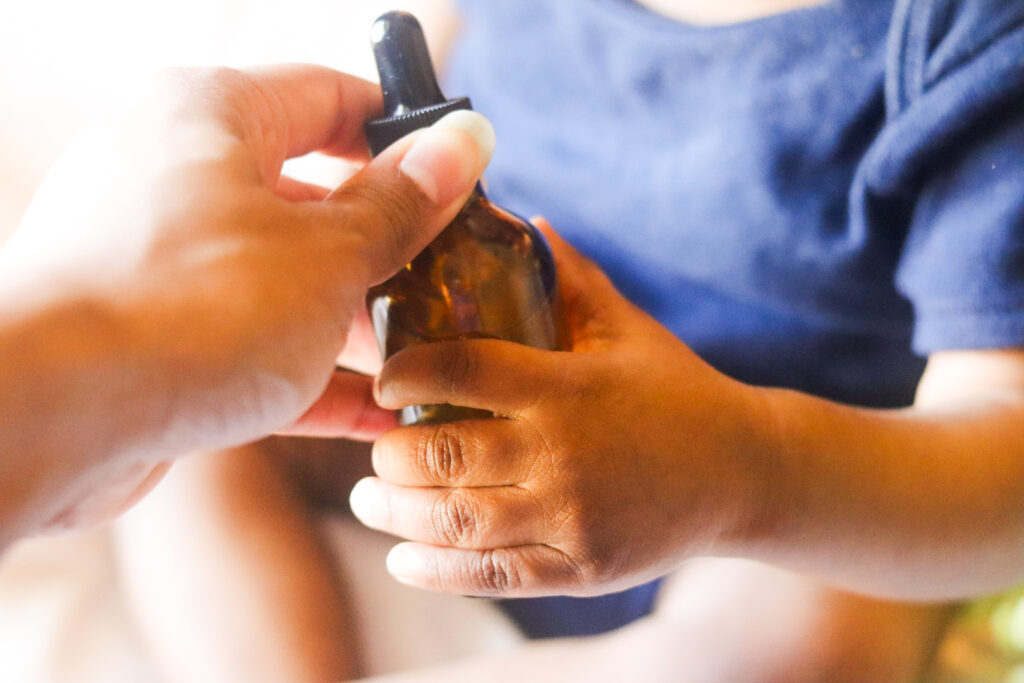 handing hair oil for infants to my infant