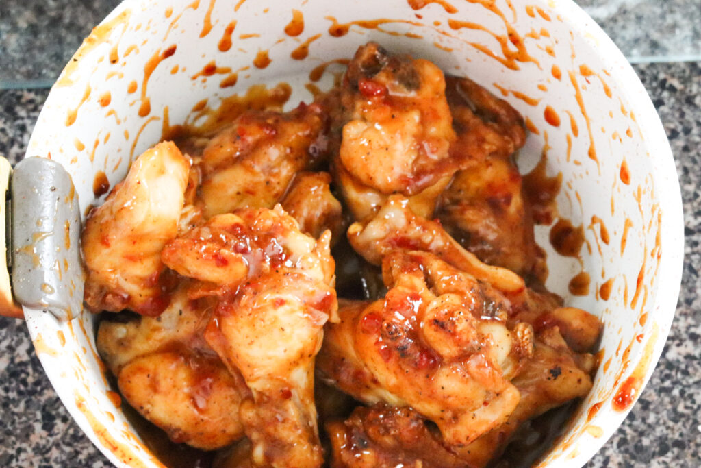 tossing sweet chili wings in sauce
