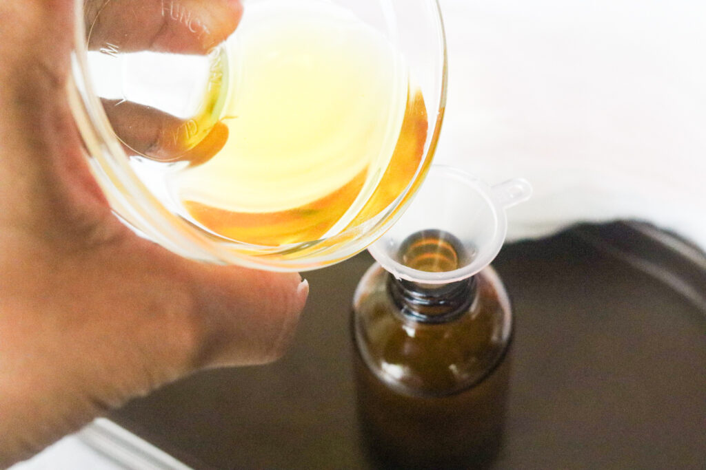 pouring ingredients into dropper bottle