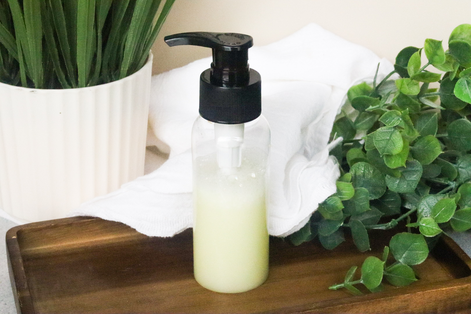 tea tree body wash on wooden tray